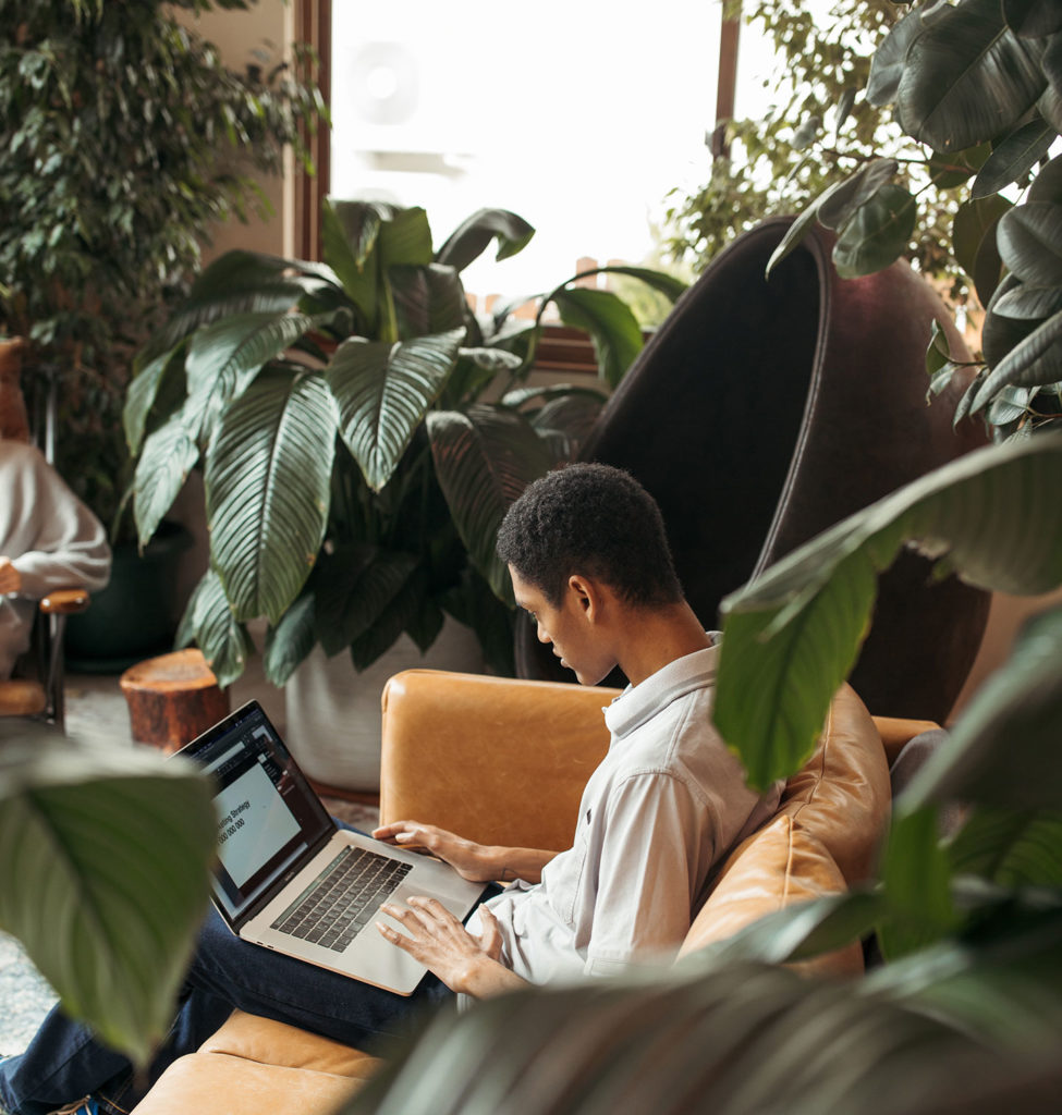 digital marketing for education man sitting on a couch with laptop