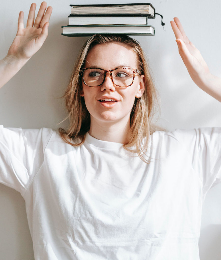 digital marketing in education sector girl with books stack on the head