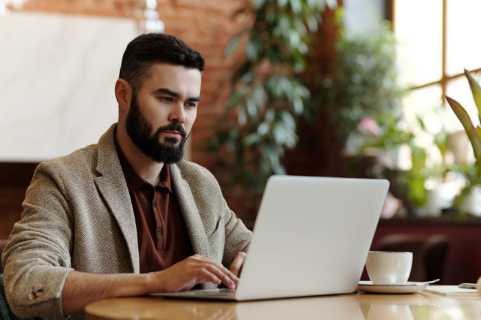 marketing automation consultant man with beard at the laptop in the office