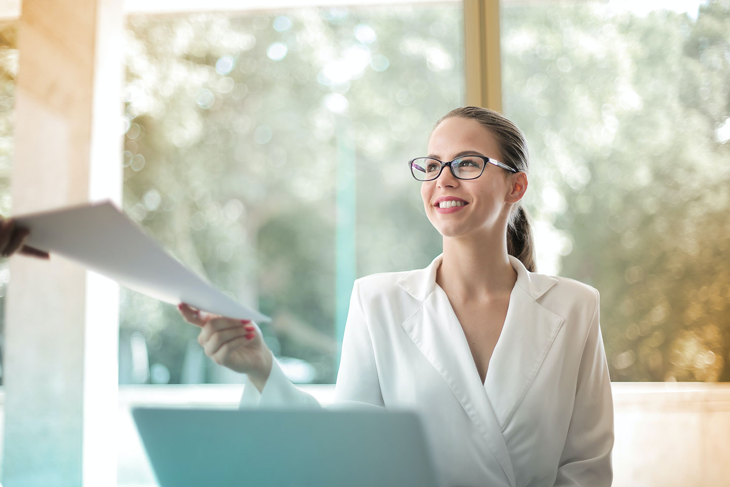 website design and development companies girl at the laptop giving a document to someone