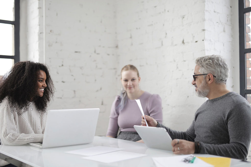 website design and development experts discussing a business card