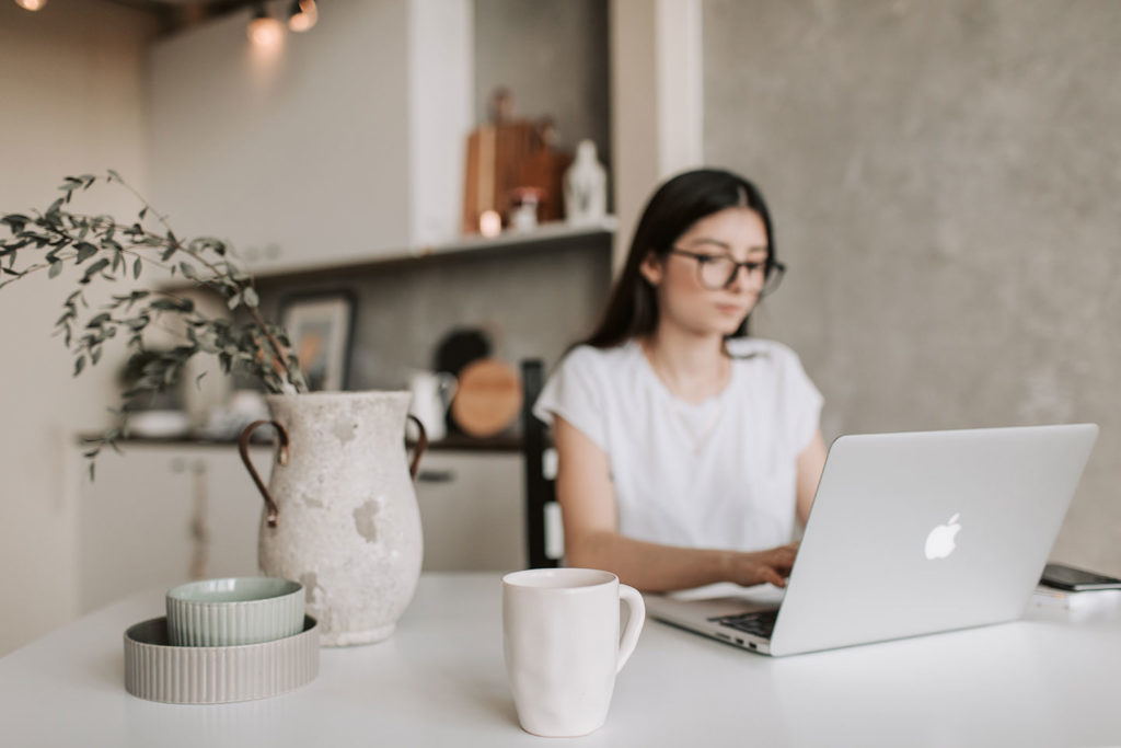 girl in glasses with laptop in the office