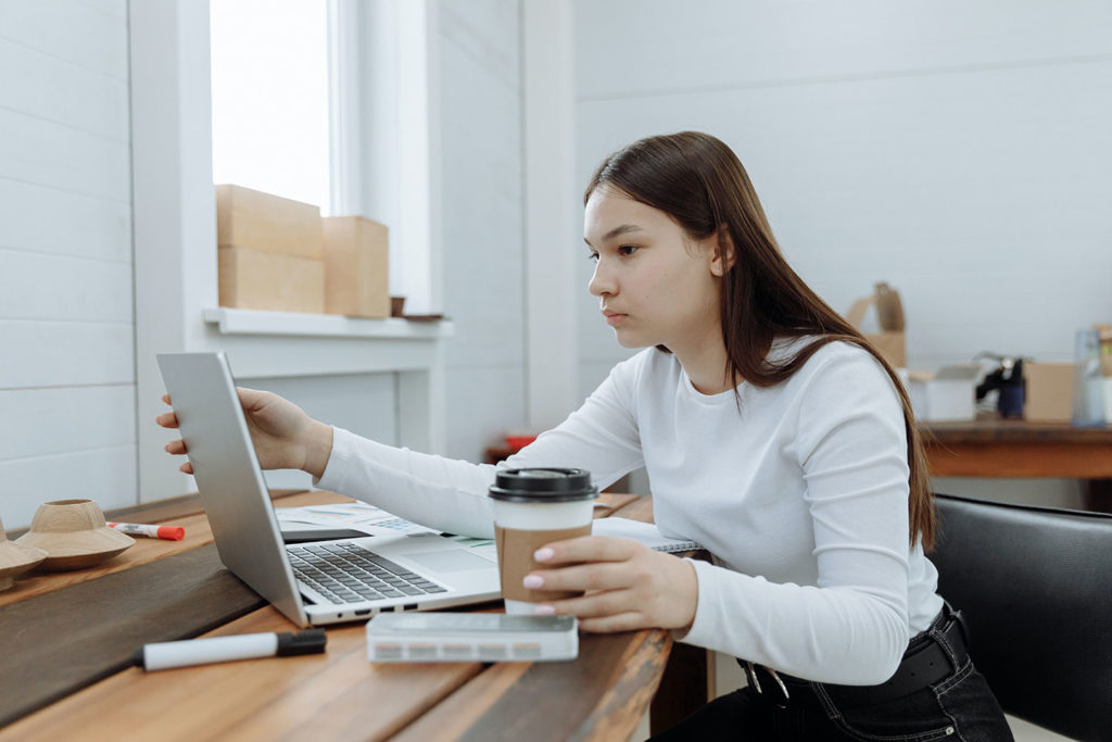 girl with laptop and coffee marketing research concept