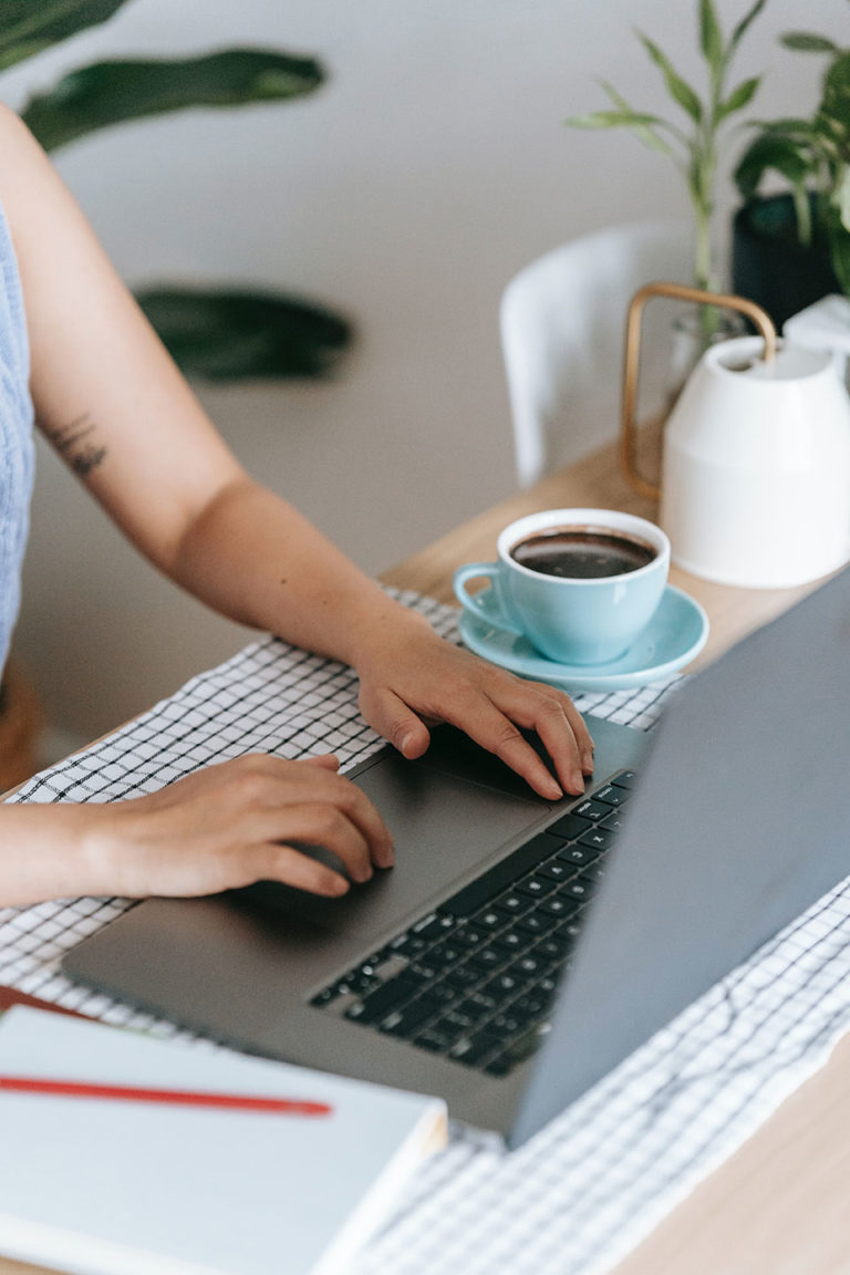 website development concept girls hands with laptop and coffee