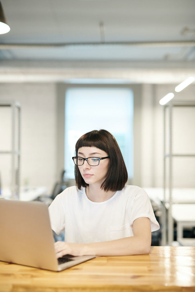 female digital marketing expert working in the office with laptop