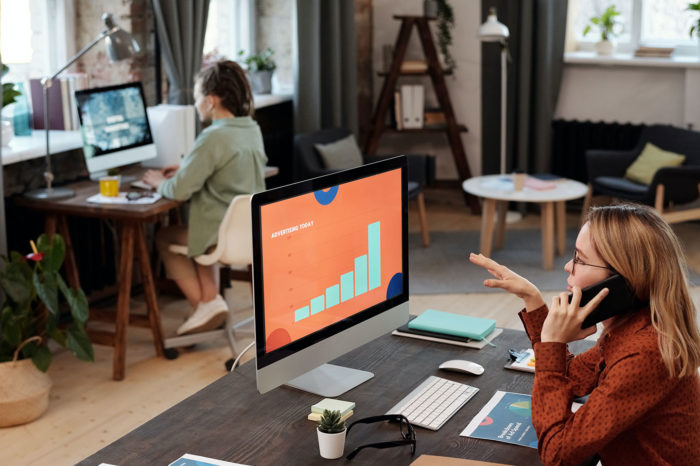 inbound marketing concept women experts in the office using imacs and talking by phone